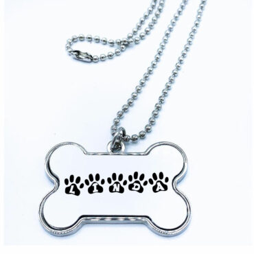 Placa de aluminio en forma de hueso para perro. Modelo Huellas 1